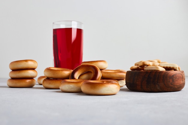 Crackers and buns served with a glass of juice. 