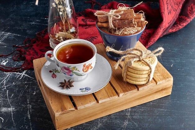 Crackers with a cup of tea and citrus fruits. 