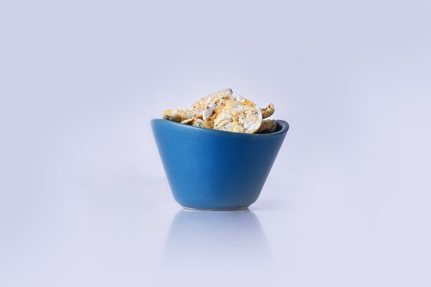 Crackers with sour cream in a blue bowl on grey