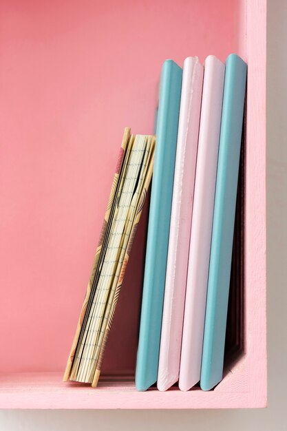 Crafting notebooks on pink shelf