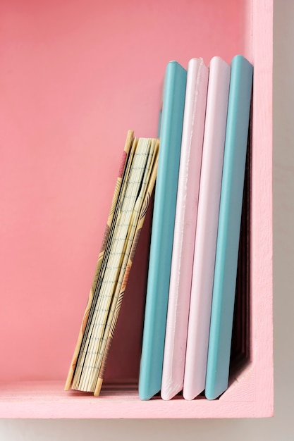 Crafting notebooks on pink shelf