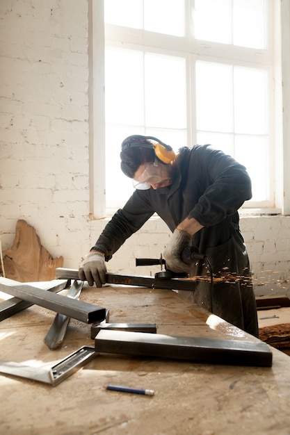 Craftsman making his new project in workshop