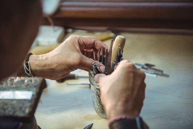 Craftswoman holding various tools