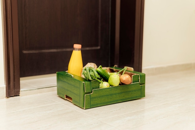 Crate of food with juice bottle