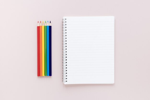 Crayons beside notebook
