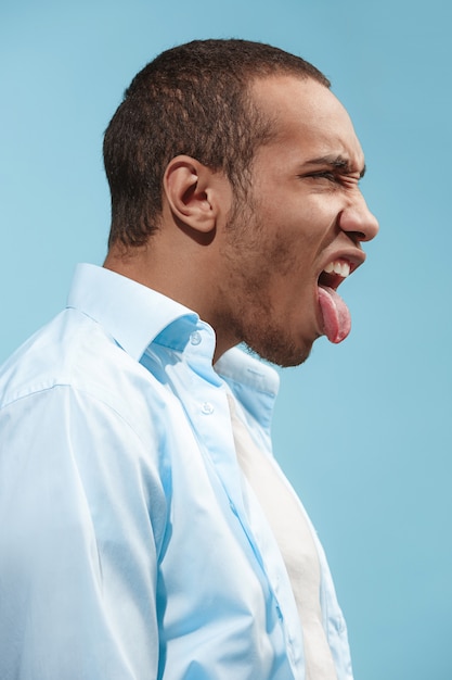 Crazy Afro-American man is looking funny against blue space