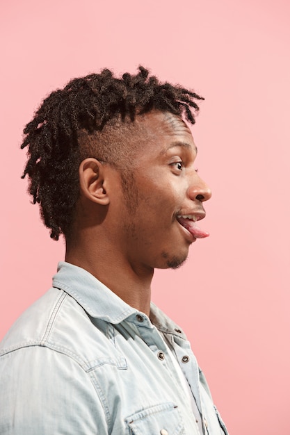 Free photo crazy business afro-american man standing and wrinkle face pink