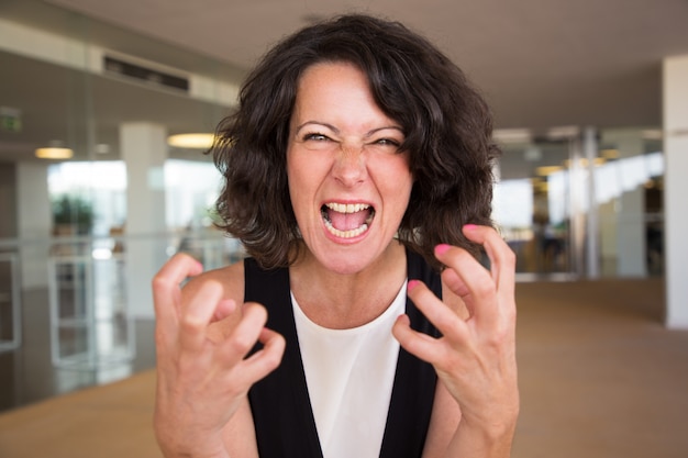 Free photo crazy furious woman shouting at camera