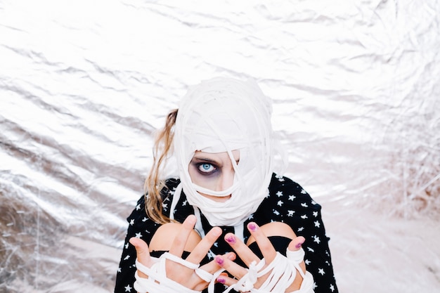 Crazy girl with bandaged head and hands