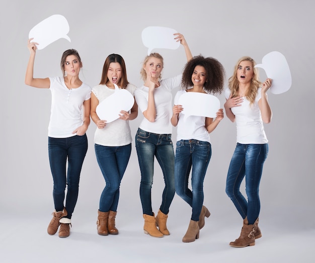 Crazy girls holding empty speech bubble