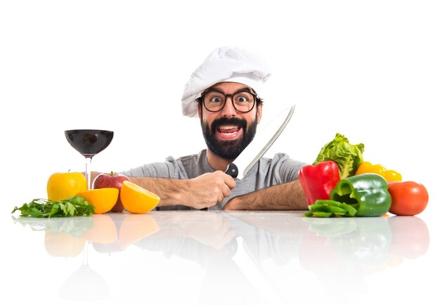 Crazy hipster chef with several vegetables and fruits