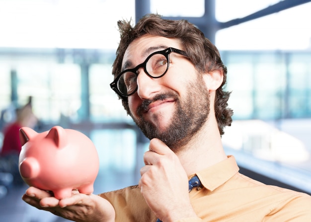 Free photo crazy man with piggy bank.funny expression