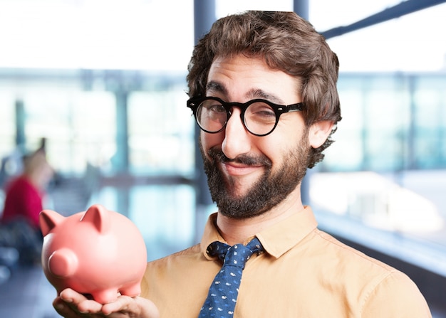 Free photo crazy man with piggy bank.funny expression