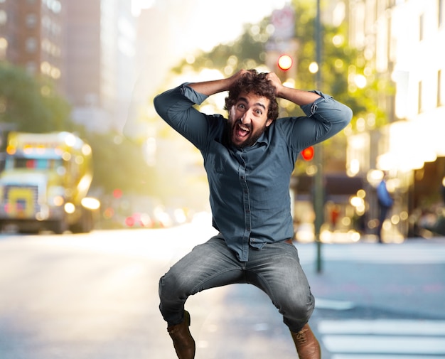 Crazy young man jumping with a happy expression – Free Stock Photo