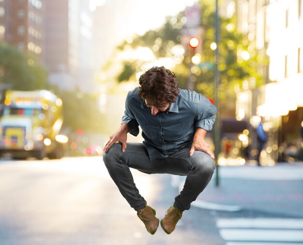 Free photo crazy young man jumping. happy expression