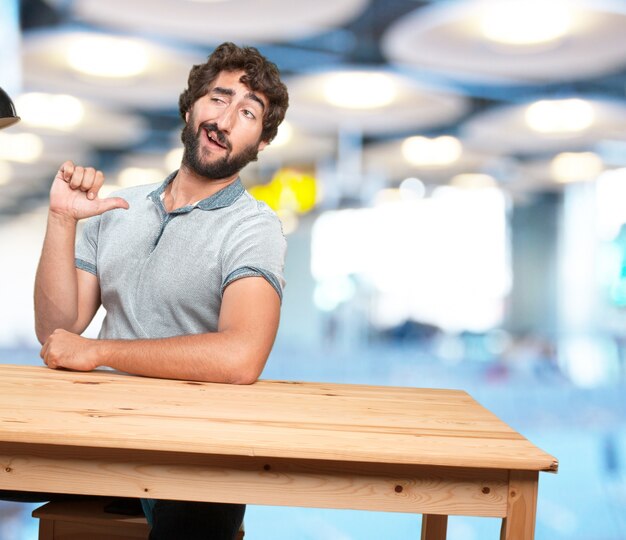 crazy young man with table .happy expression