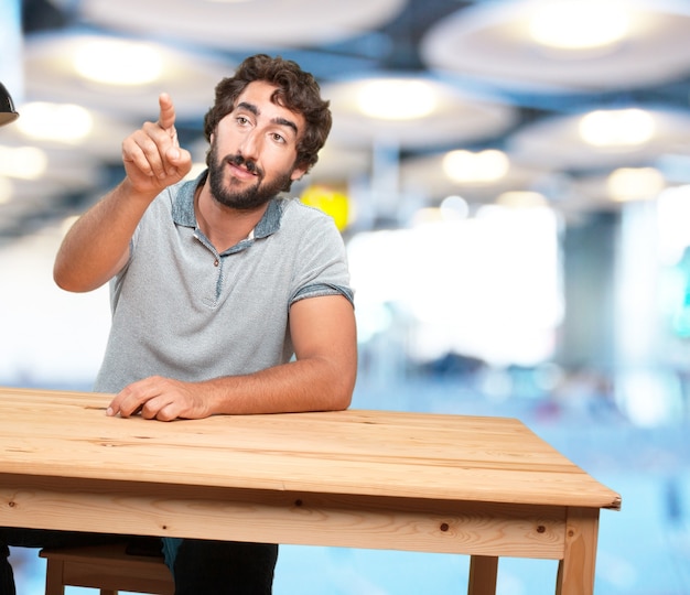 crazy young man with table .happy expression