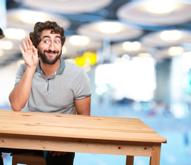 crazy young man with table .happy expression