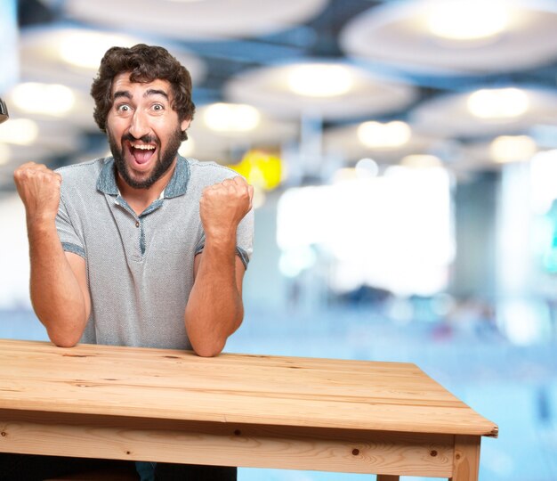 crazy young man with table .happy expression