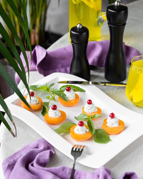 Cream apricot appetizers decorated with leaves