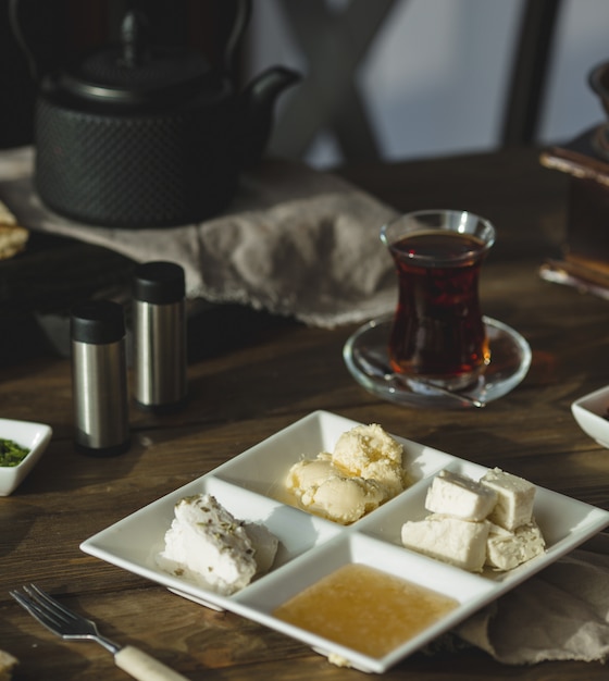 Cream cheese, honey and butter with a glass of tea