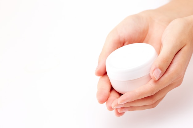 Cream container in woman hands