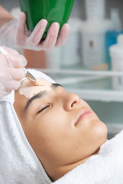 Cream making on woman forehead