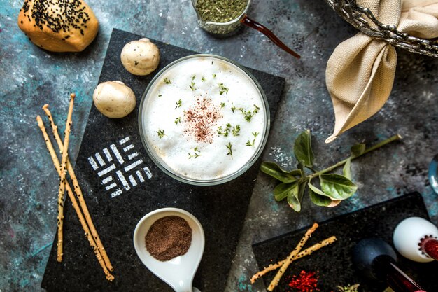 Cream mushroom soup served with herbs and spices.