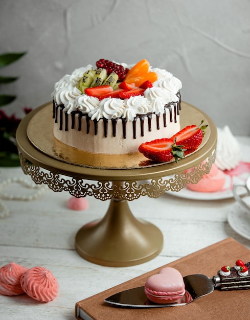 Creamy cake with strawberries on the table