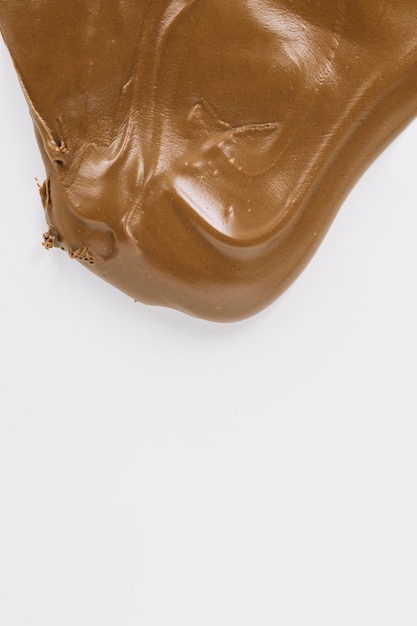 Creamy chocolate spread on white background