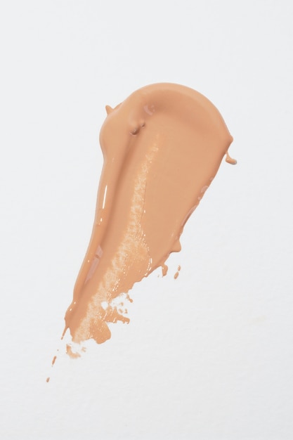 Creamy foundation  on white background flat lay