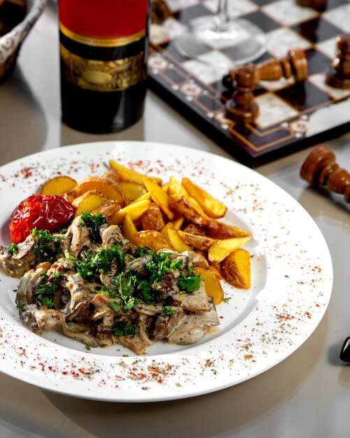 Creamy mushroom topped with herbs and fried potatoes