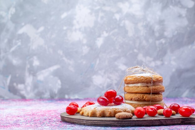 creamy sandwich cookies with fresh red dogwoods on bright, cookie cake biscuit sweet sour fruit berry