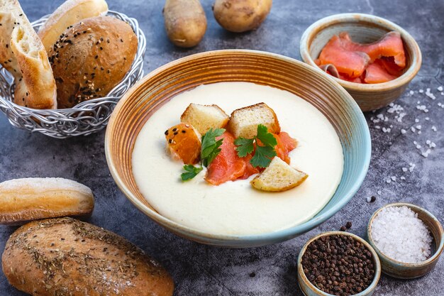 Creamy soup bowl garnished with salmon bread stuffing and parsley