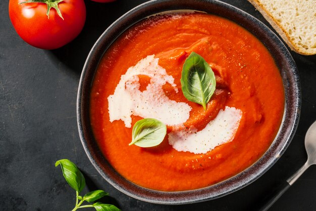 Creamy tomato soup served in bowl