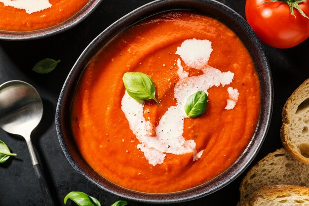 Creamy tomato soup served in bowl