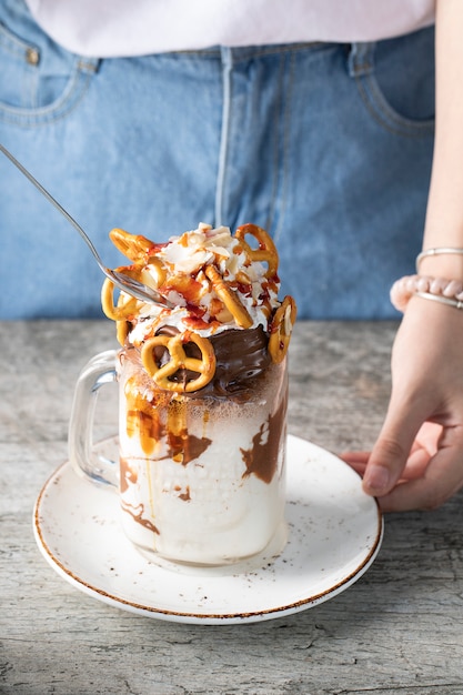 Creamy vanilla milky shake with pretzels in a white saucer