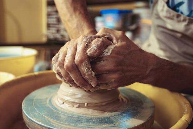 Creating a jar or vase of white clay close-up. Master crock.