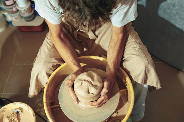 Creating a jar or vase of white clay close-up. Master crock.