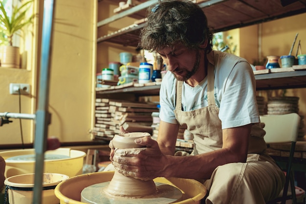 Free photo creating a jar or vase of white clay close-up