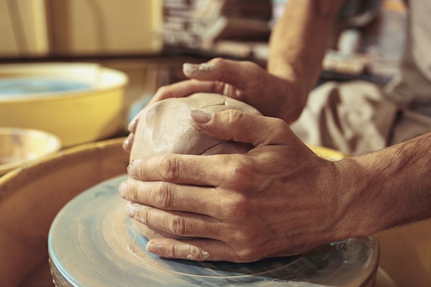 Creating a jar or vase of white clay close-up.