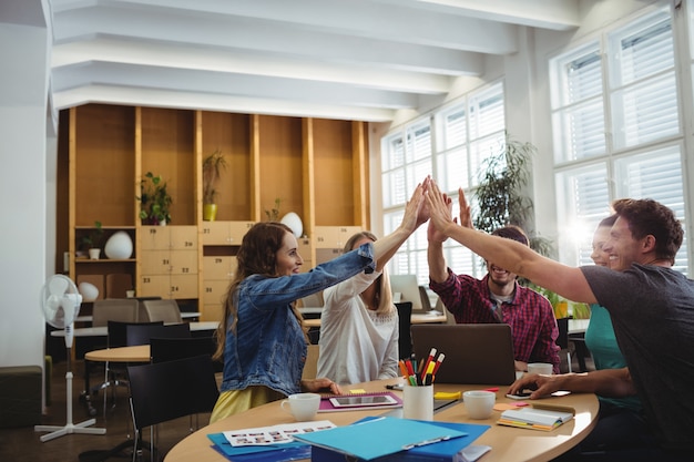 Creative business team putting hands together