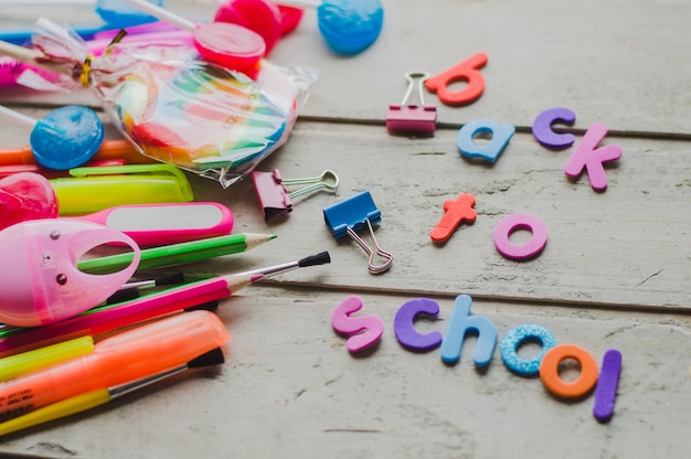 Free photo creative colorful arrangement of pens and letters