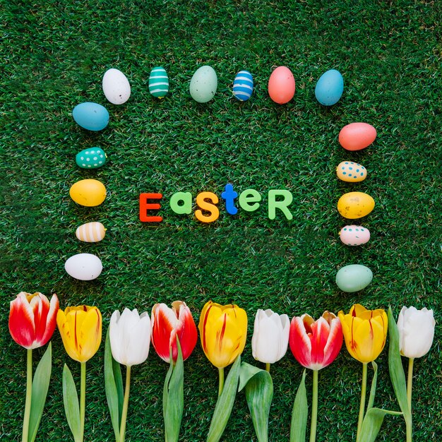 Creative composition of flowers and Easter eggs