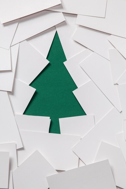 Creative design of christmas background with paper green fir tree from business cards