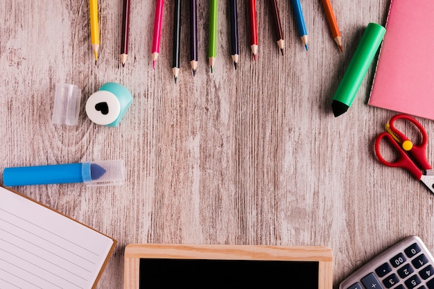 Creative desk with stationery on wooden table