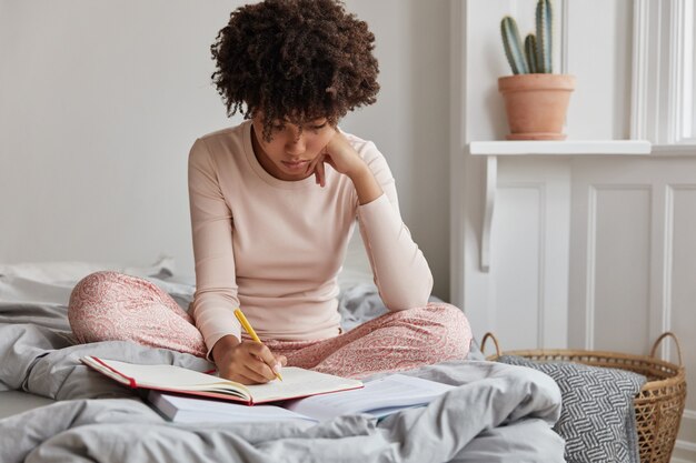 creative girl posing at home in comfortable bed