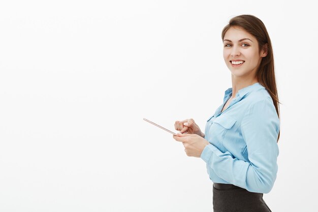 Creative good-looking brunette businesswoman posing in the studio