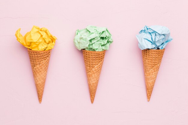 Creative ice cream from crumpled colorful paper in waffle cones