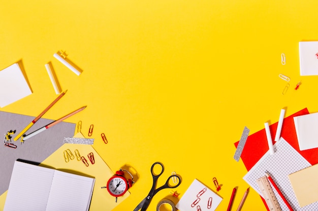 Creative mess of colorful school supplies on desk.